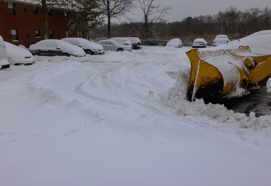 snowy parking lot being plowed